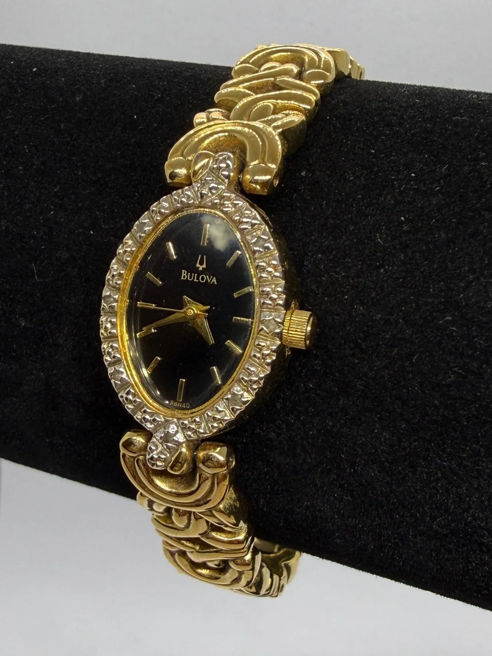Bulova Gold Tone Dainty Oval Wristwatch Black Dial Textured Bezel Link Bracelet
